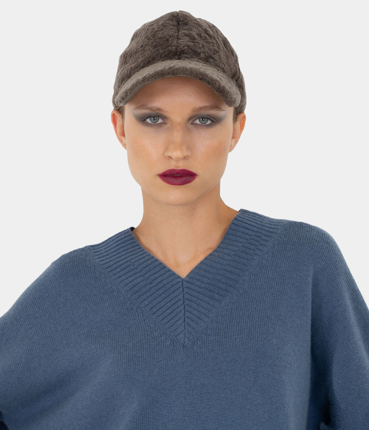 Brown astrakhan-pattern shearling baseball cap by Dom Goor on a model, front view