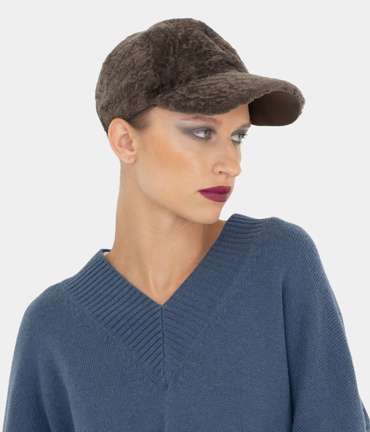 Model wearing the Dom Goor brown astrakhan-pattern shearling baseball cap, three-quarter view