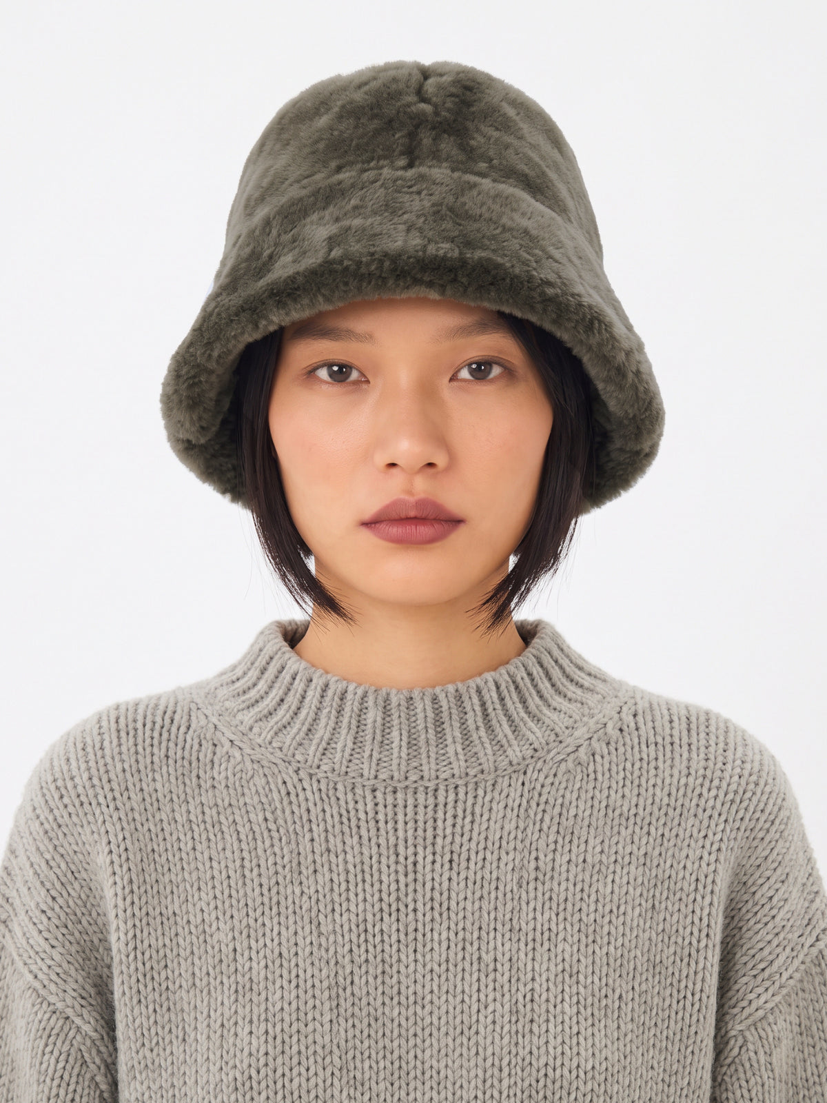 Olive shearling bucket hat by Dom Goor on a model, front view