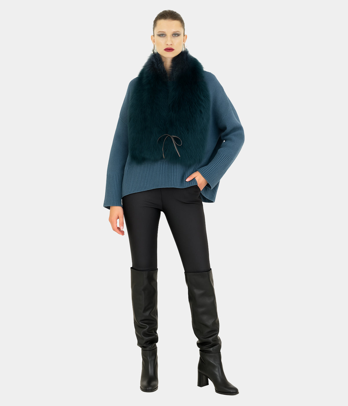 Model wearing the Dom Goor cerulean blue Toscana shearling tie scarf with a blue jumper, full-length view