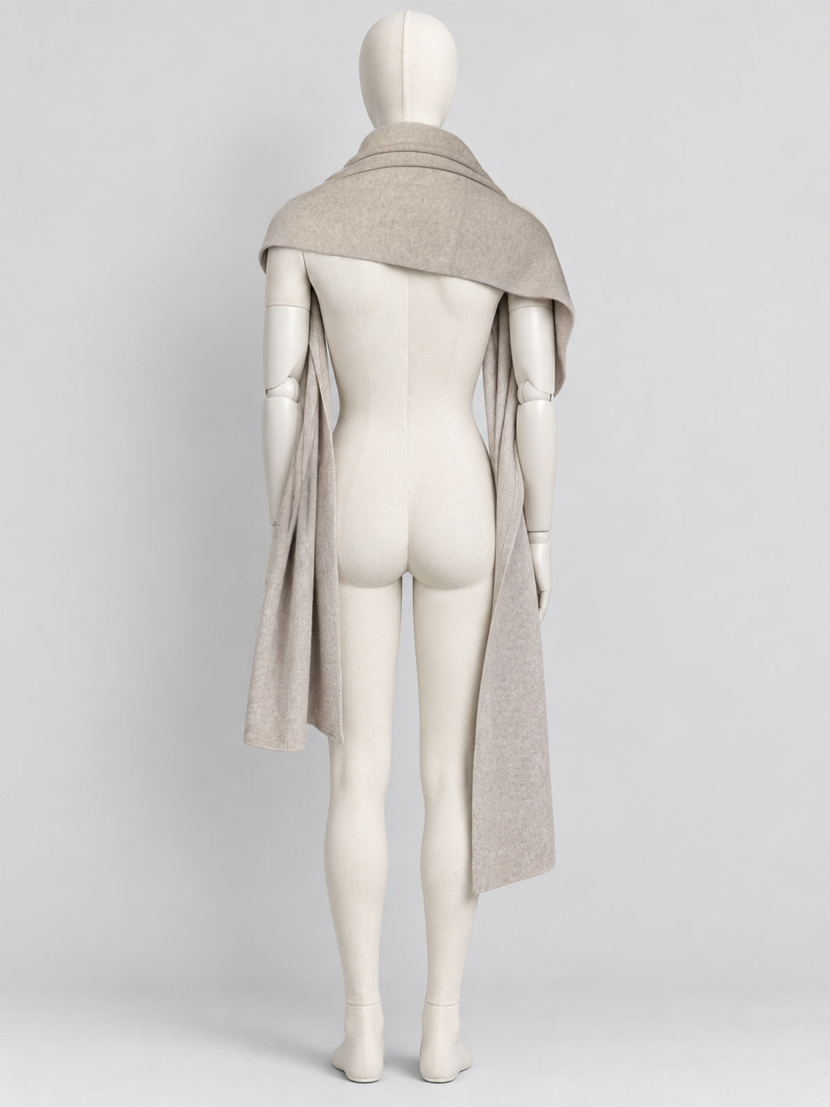 Back view of the Dom Goor Oyster Donegal Merino wool scarf wrapped over a mannequin's shoulders