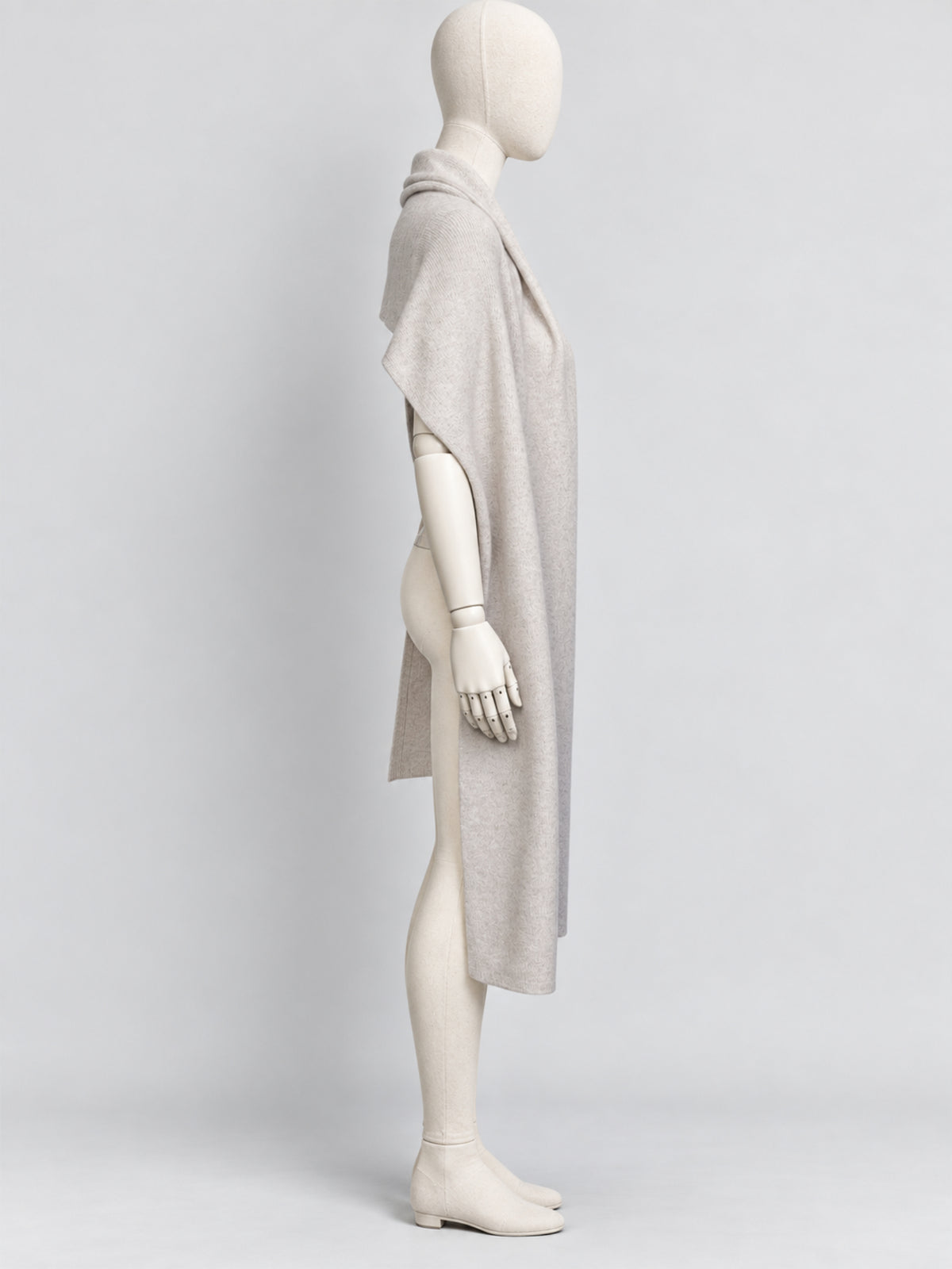 Side view of the Dom Goor Oyster Donegal Merino wool scarf on a mannequin