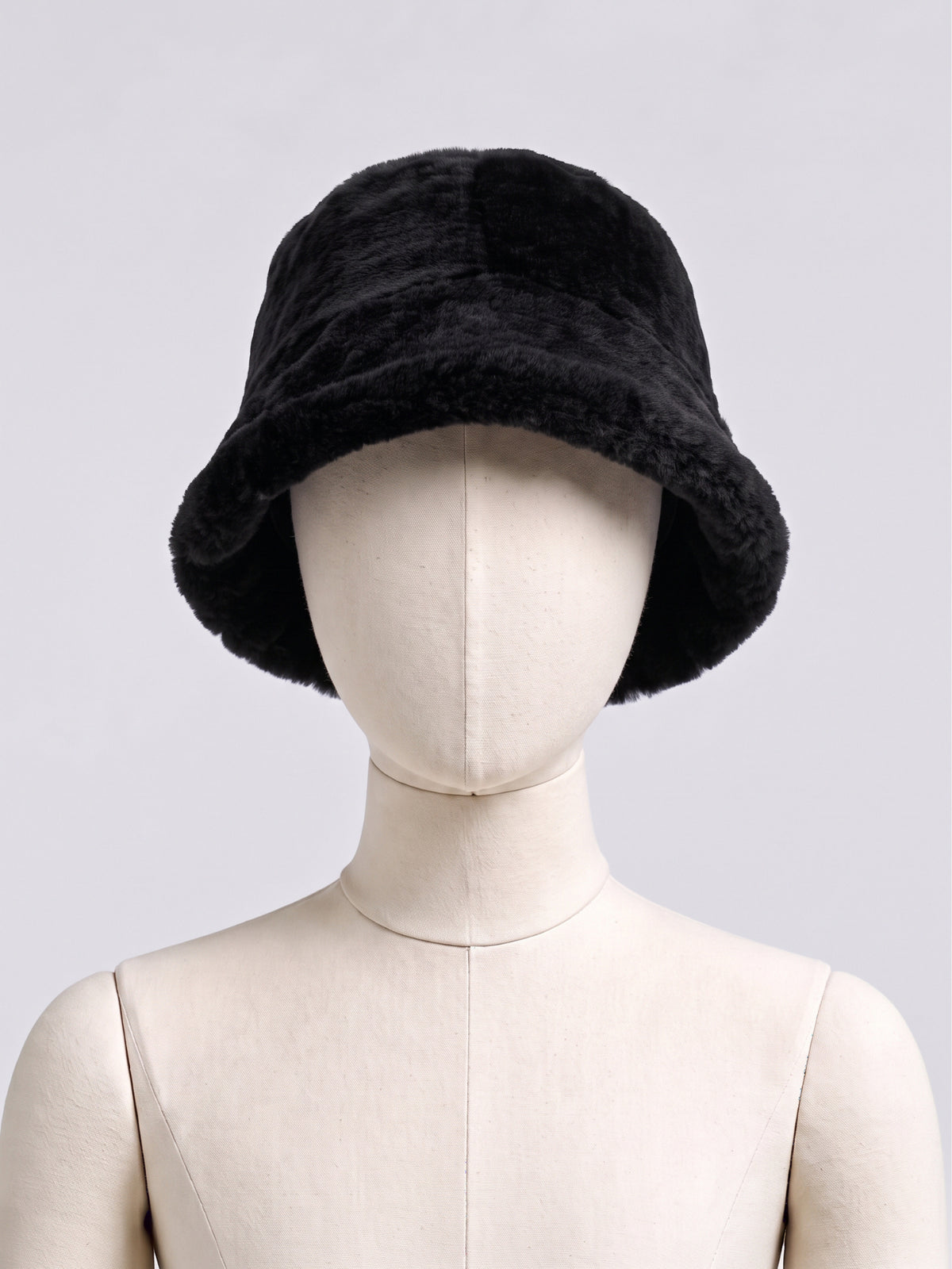 Black shearling bucket hat by Dom Goor displayed on a mannequin head
