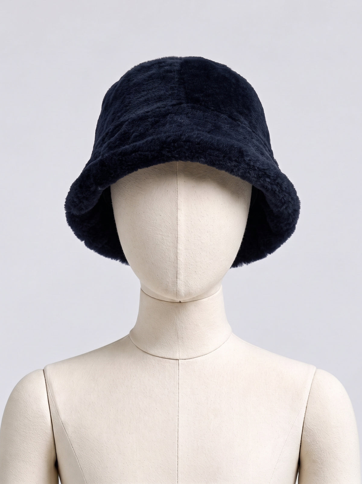 Navy shearling bucket hat by Dom Goor displayed on a mannequin head