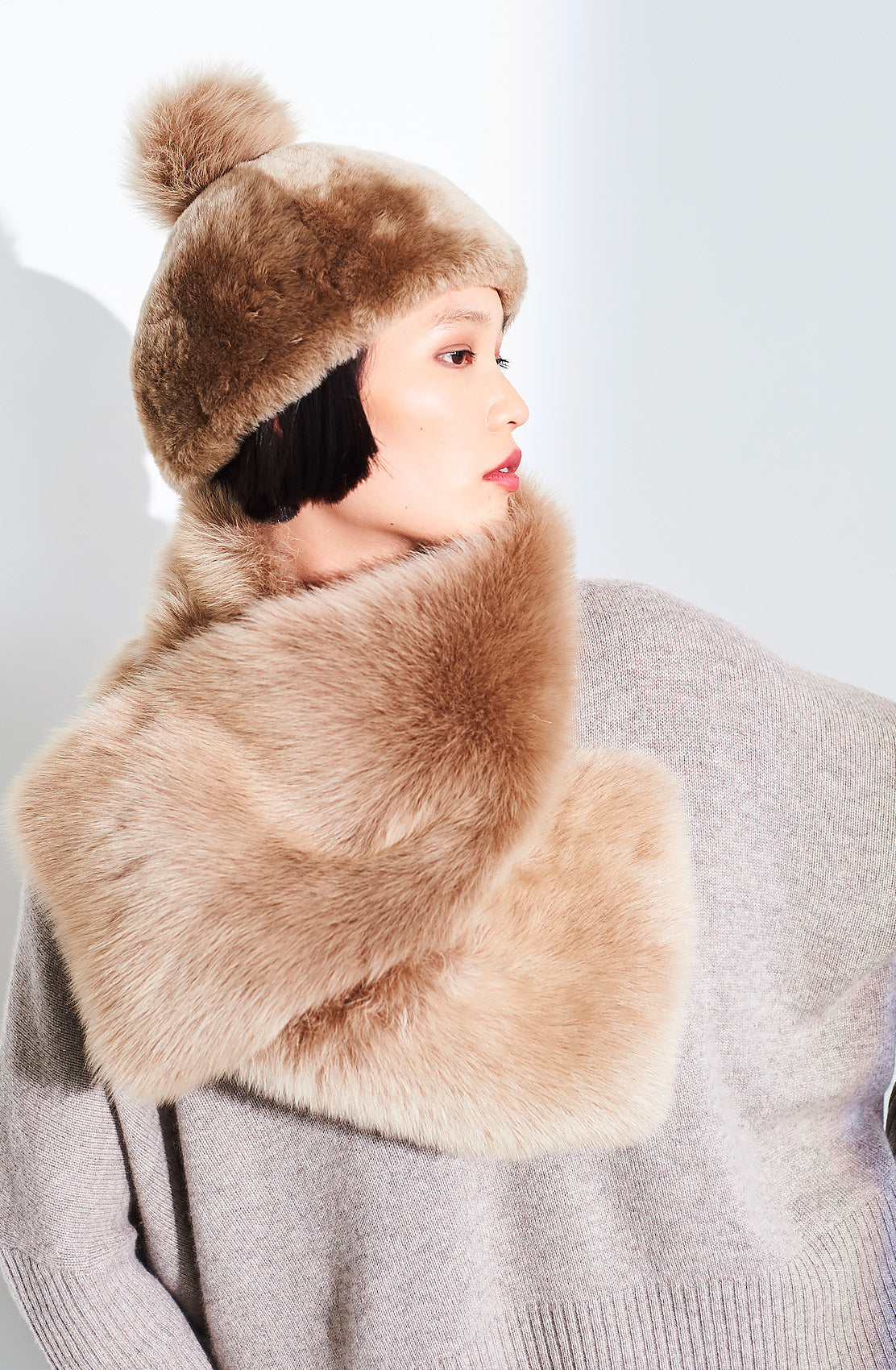 Beige Toscana side tie scarf by Dom Goor wrapped around the neck, model in profile